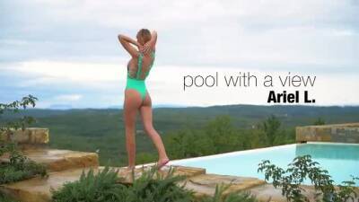 Lovely girl has a swimming pool with an amazing view, and likes posing nude next to it on freereelz.com