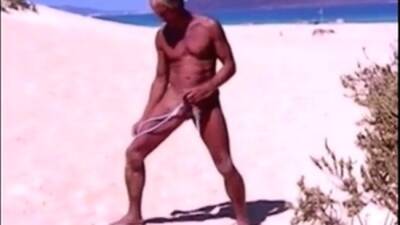 Tanned guy on beach in tiny string thong (temporarily!) on freereelz.com