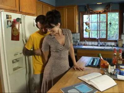 Lusty brunette milf in glasses seduced man next door on her kitchen counter on freereelz.com