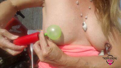 Nippleringlover Horny Milf Sticking Balloons Through Extreme Stretched Pierced Nipples Outdoors on freereelz.com