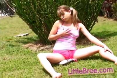 Petite Teen Strips Off Outdoors On The Grass on freereelz.com