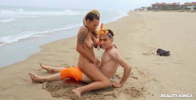 Inked hussy Lola Emme fucks horny dude on the beach on freereelz.com