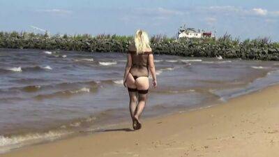 Pretty Woman In A Nylon Bodysuit On The Beach on freereelz.com