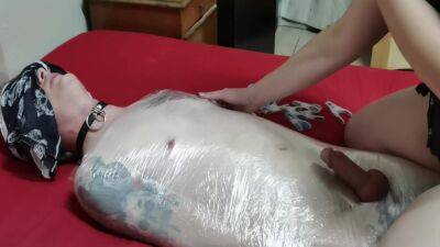 Mistress Wraps Her Slave In Clingwrap on freereelz.com