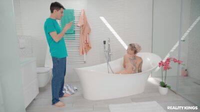 Inked MILF welcomes horny stepson into the tub for some sex fun on freereelz.com