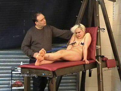 Busty blonde is punished with hot wax and hard spanking on freereelz.com