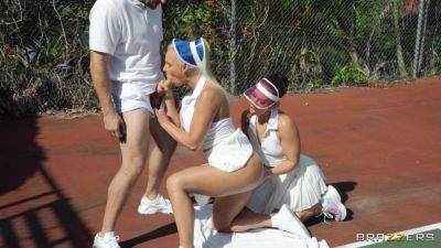 Sporty females take turns when sharing dick on the tennis court on freereelz.com