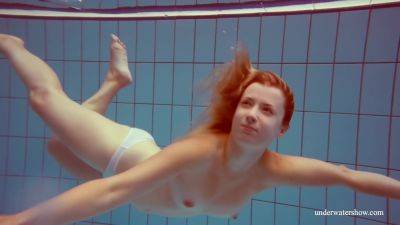 In The Indoor Pool, A Stunning Girl Swims on freereelz.com