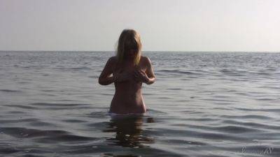 Divine Blonde Teen Blissfully Naked in the Sea on freereelz.com