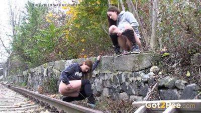 Watch these kinky girls get soaked in pee while getting frisky on the railway on freereelz.com