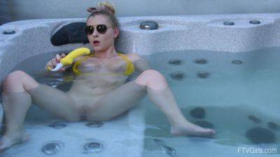 Sweet blonde inserts big dildo in her shaved pussy while in the pool on freereelz.com