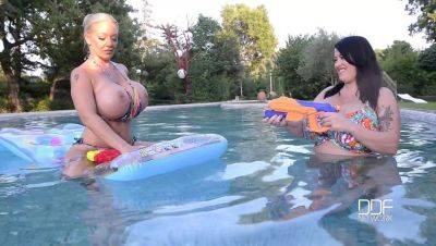 Floating Gazongas: Two British Bombshells With Big Tits In The Pool - Britain on freereelz.com